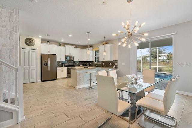 dining room featuring sink and a chandelier