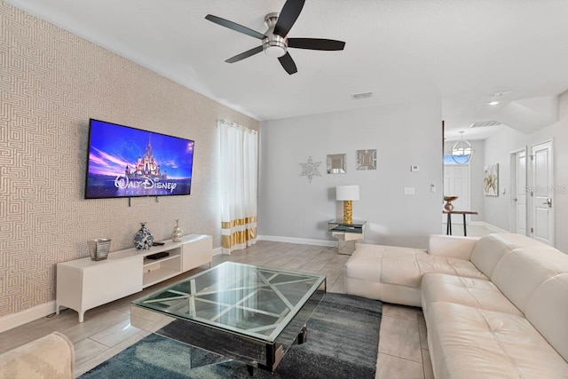 living room with plenty of natural light, tile patterned floors, and ceiling fan