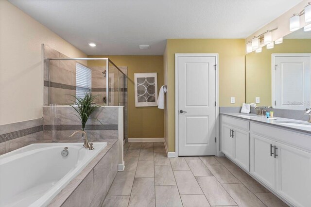 bathroom with independent shower and bath, vanity, and tile patterned flooring