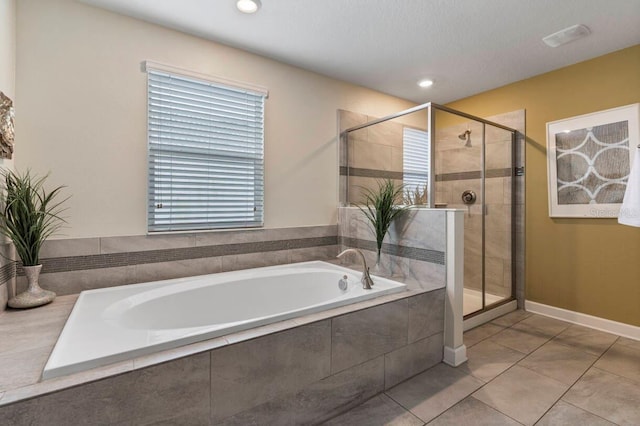 bathroom with shower with separate bathtub and tile patterned floors