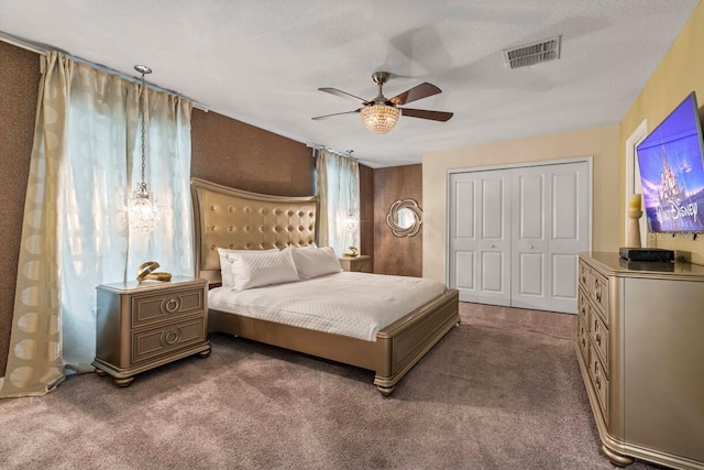 bedroom featuring a textured ceiling, carpet floors, a closet, and ceiling fan