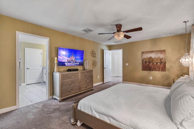 carpeted bedroom featuring ceiling fan with notable chandelier