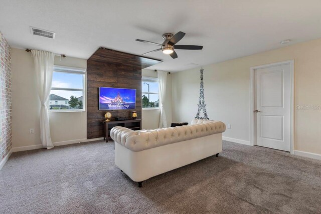 carpeted living room with ceiling fan