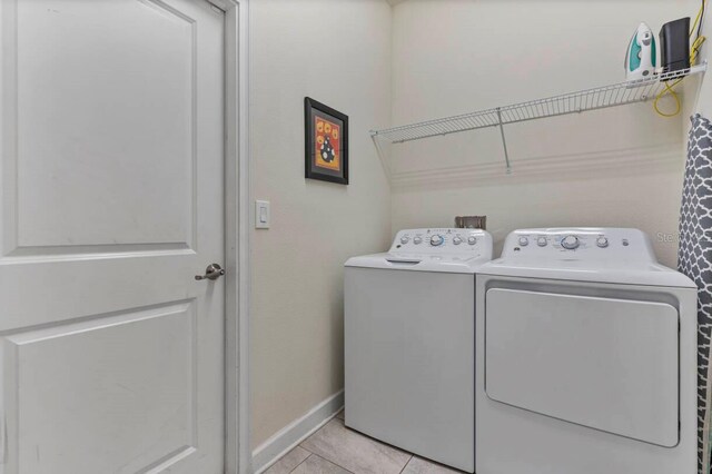 laundry room with light tile patterned floors and independent washer and dryer