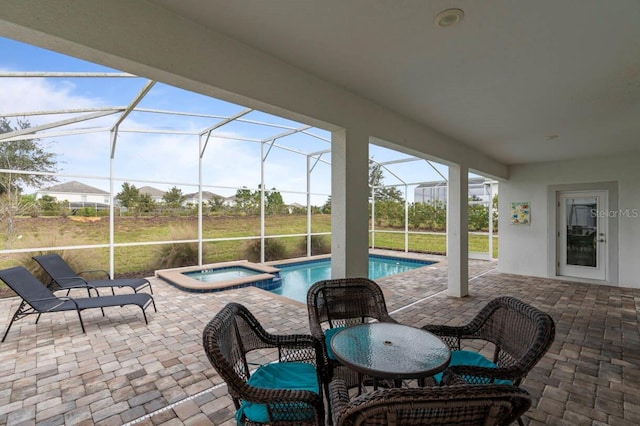 view of patio / terrace featuring a pool with hot tub and a lanai