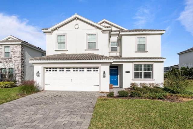 view of property featuring a garage and a front yard