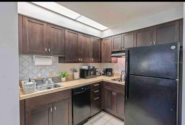 kitchen with backsplash, dark brown cabinetry, black appliances, and light tile flooring