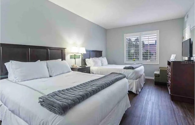 bedroom with dark wood-type flooring