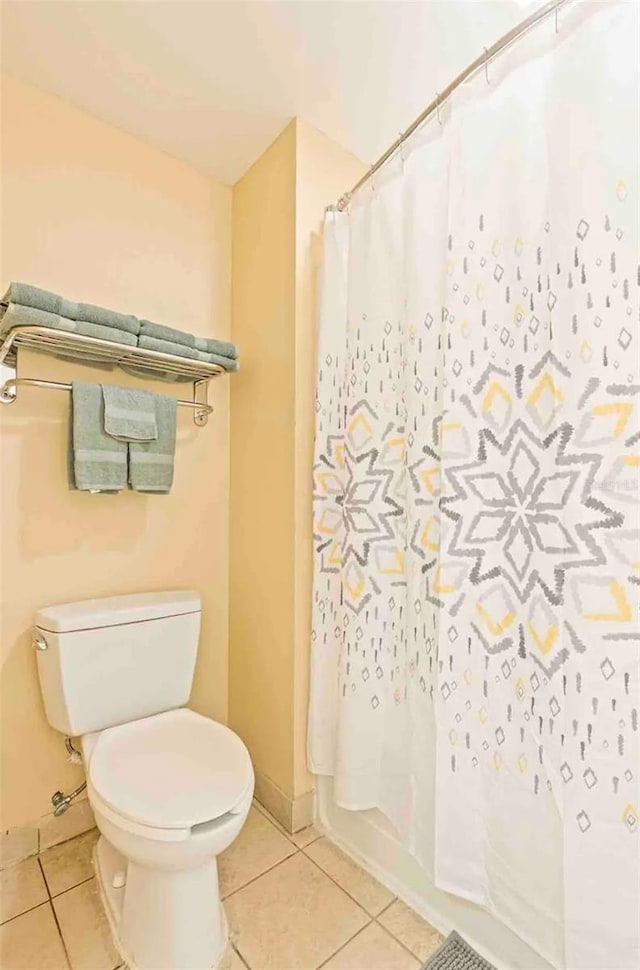 bathroom with tile floors and toilet