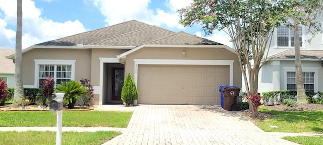 view of front of home featuring a garage and a front lawn