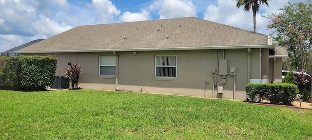 back of property featuring a lawn