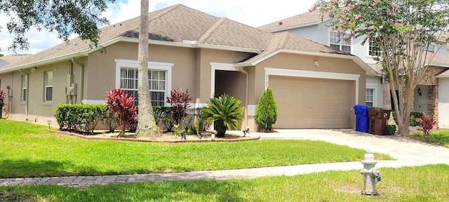 view of front of home with a front yard and a garage