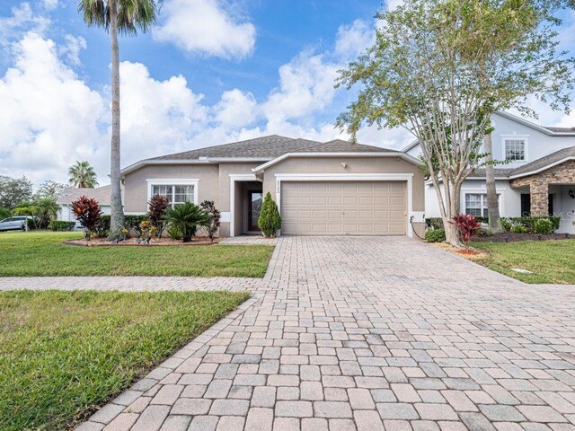 view of front of property with a garage and a front lawn