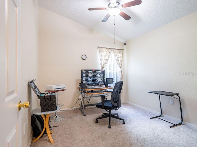 office area with light carpet, a textured ceiling, vaulted ceiling, and ceiling fan