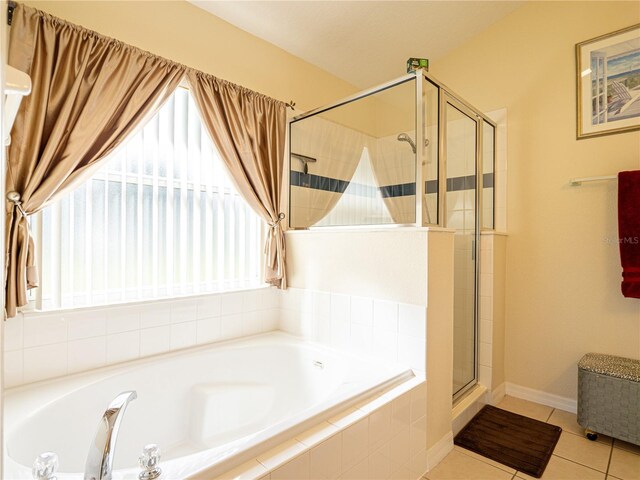 bathroom featuring plus walk in shower and tile patterned floors