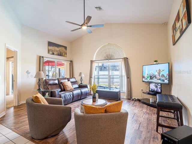 living room featuring high vaulted ceiling, ceiling fan, and a wealth of natural light