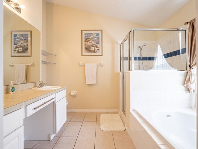 bathroom featuring tile patterned floors, vanity, vaulted ceiling, and shower with separate bathtub