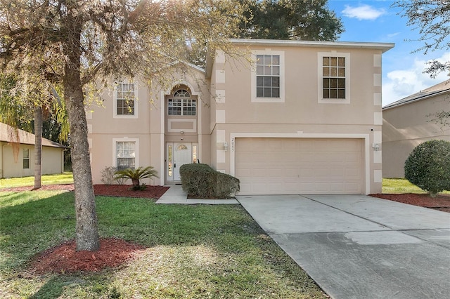 view of front of property featuring a front yard and a garage