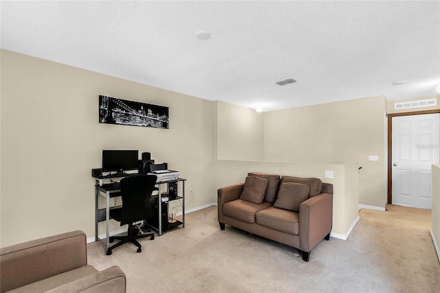 home office featuring a textured ceiling and light colored carpet