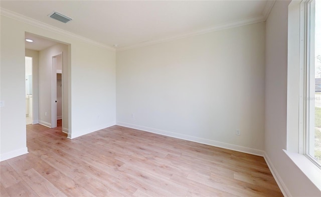 spare room featuring light hardwood / wood-style floors and ornamental molding