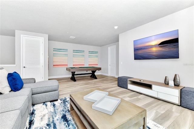 living room with pool table and light hardwood / wood-style floors