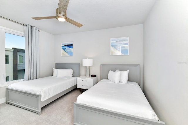 bedroom featuring light carpet and ceiling fan