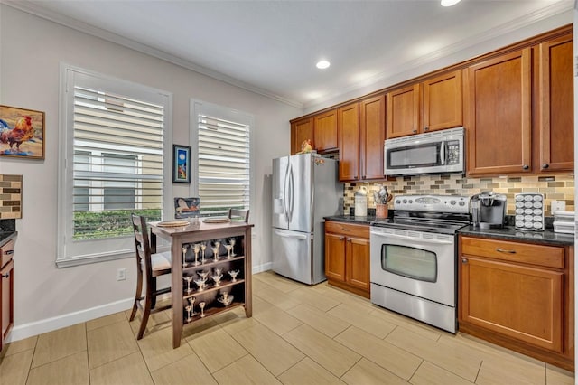 kitchen featuring tasteful backsplash, ornamental molding, appliances with stainless steel finishes, and plenty of natural light