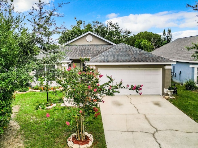 single story home with a garage and a front yard