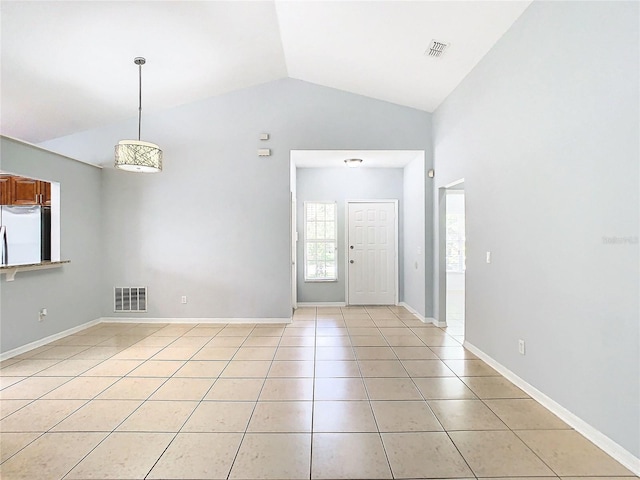 tiled entryway featuring vaulted ceiling