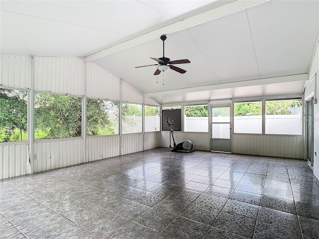 unfurnished sunroom with vaulted ceiling with beams, ceiling fan, and a healthy amount of sunlight