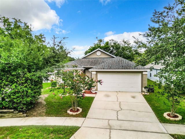 view of front of property featuring a front yard and a garage