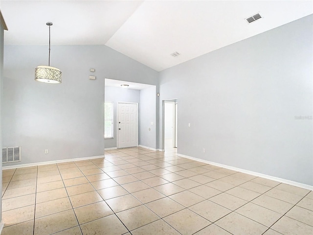 unfurnished room featuring light tile patterned floors and vaulted ceiling