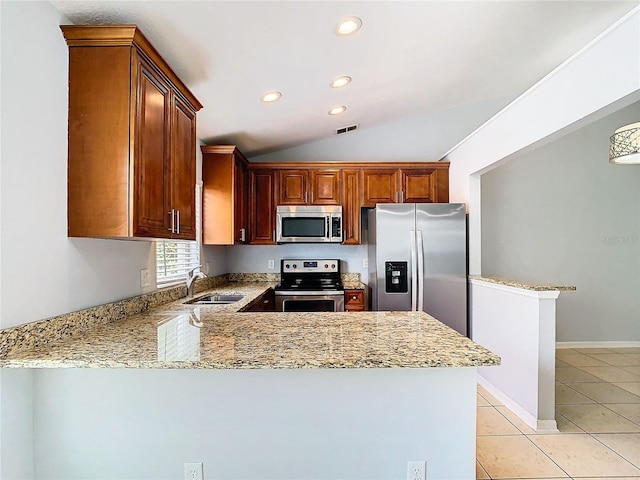 kitchen with kitchen peninsula, stainless steel appliances, vaulted ceiling, sink, and light tile patterned floors