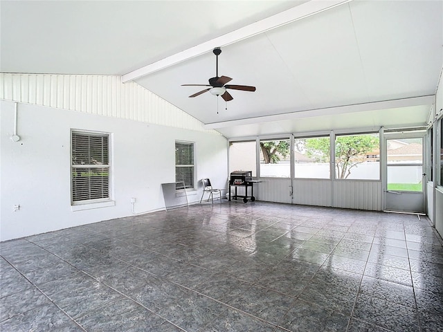 interior space with vaulted ceiling with beams, a wealth of natural light, and ceiling fan