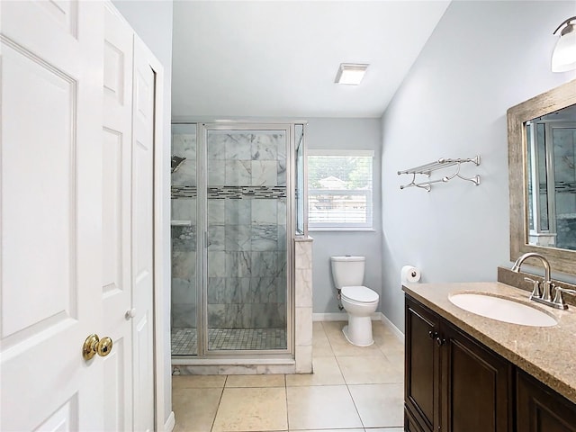 bathroom featuring tile patterned floors, vanity, an enclosed shower, and toilet