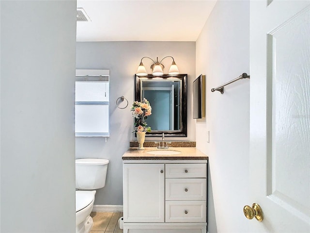 bathroom with tile patterned floors, vanity, and toilet