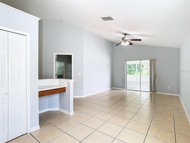 unfurnished room with ceiling fan, light tile patterned flooring, and lofted ceiling