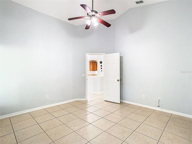 tiled spare room featuring ceiling fan and high vaulted ceiling