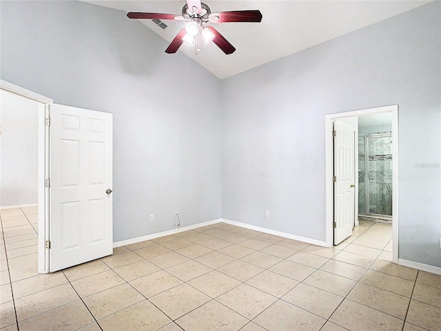 spare room featuring ceiling fan, light tile patterned floors, and high vaulted ceiling