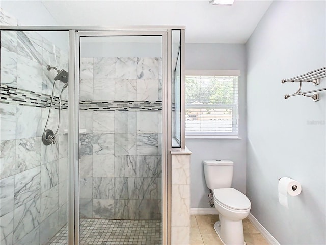 bathroom with toilet, tile patterned floors, and a shower with door