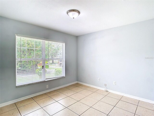 unfurnished room featuring light tile patterned floors