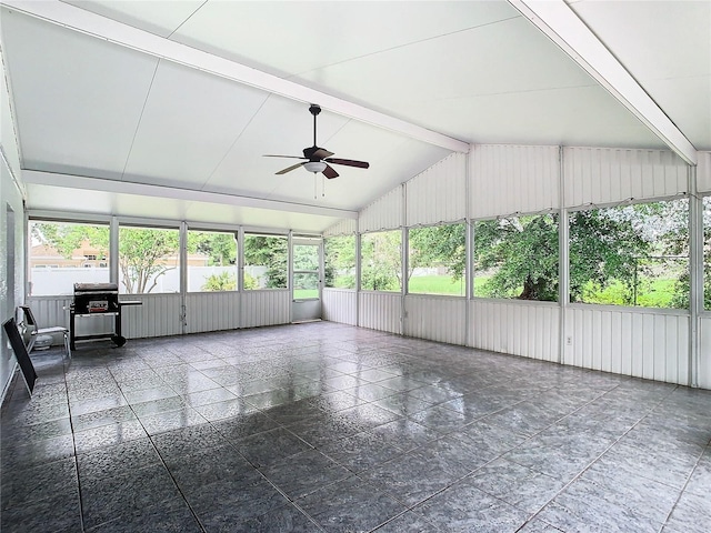 unfurnished sunroom with ceiling fan and lofted ceiling with beams