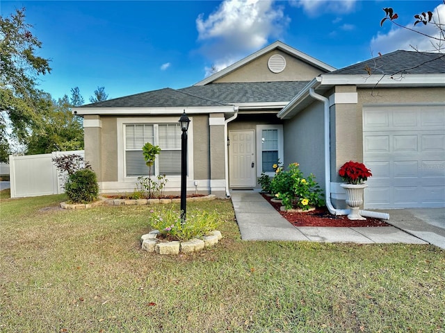 ranch-style home with a garage and a front yard