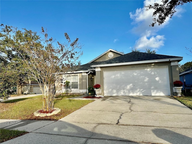 single story home featuring a garage and a front lawn