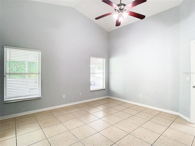 empty room featuring ceiling fan, light tile patterned floors, and vaulted ceiling