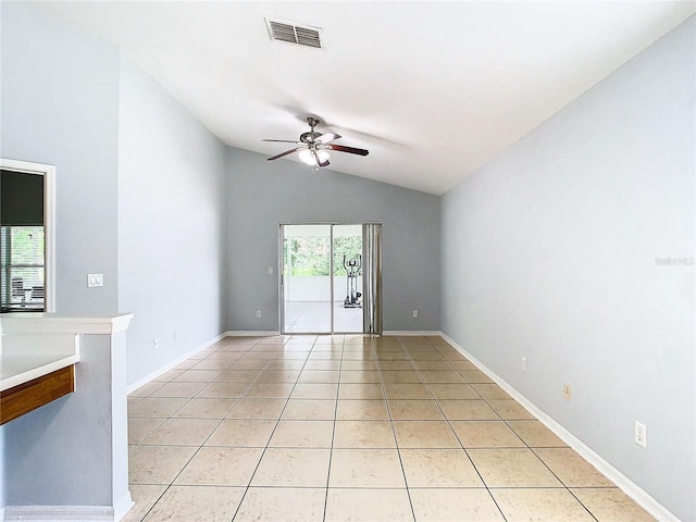 tiled empty room featuring a wealth of natural light, ceiling fan, and lofted ceiling