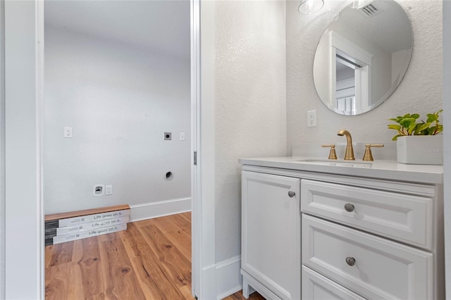 bathroom with vanity and wood-type flooring