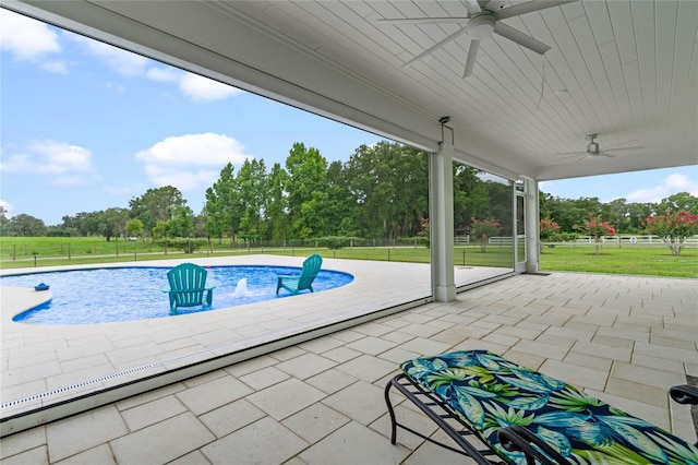 view of swimming pool featuring a lawn, a patio area, ceiling fan, and pool water feature