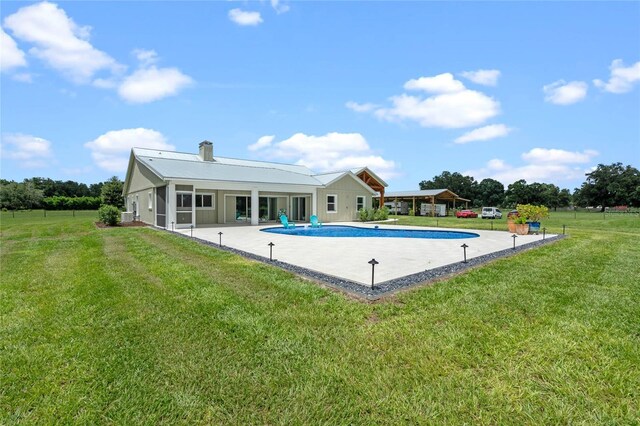 view of swimming pool featuring a yard and a patio area