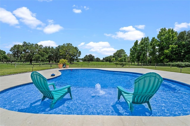 view of swimming pool with a yard